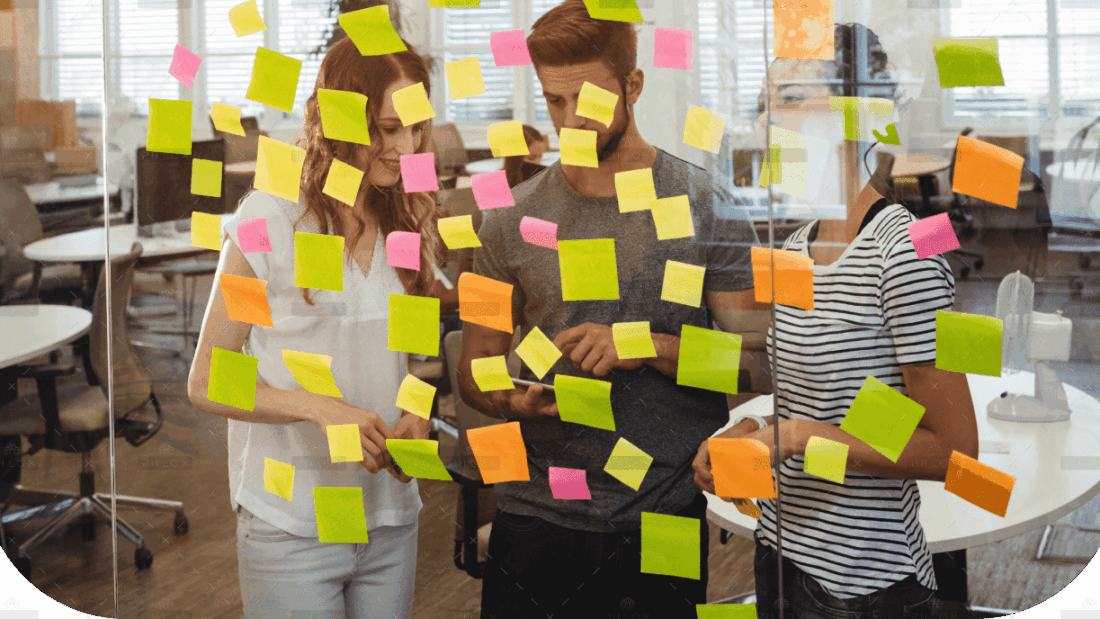 demo-attachment-1495-business-executives-standing-near-glass-with-sticky-notes-di-1-1