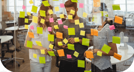 demo-attachment-1495-business-executives-standing-near-glass-with-sticky-notes-di-1-1
